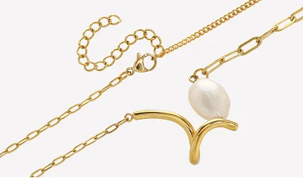 Gold chain necklace featuring a curved gold pendant and a white baroque pearl, displayed on a clean white background.